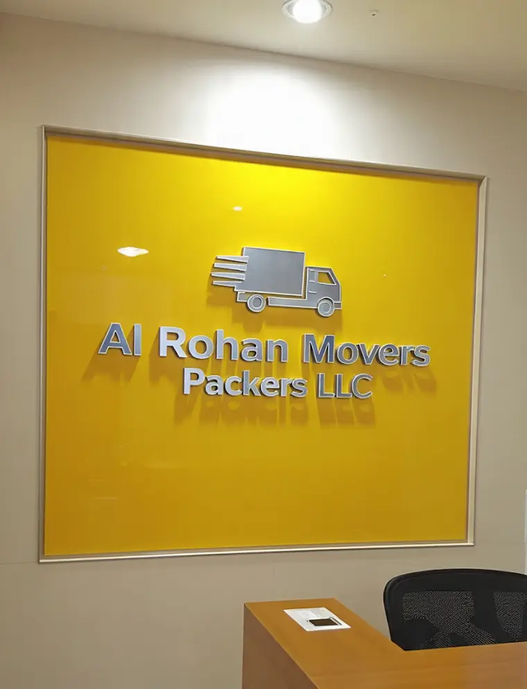 The Al Rohan Movers Packers LLC sign on a yellow wall at their office